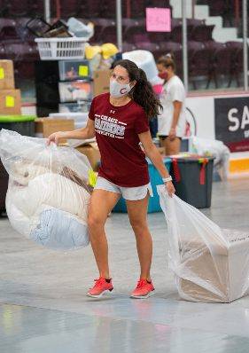 Athletics Staff sort student belongings in Starr Rink