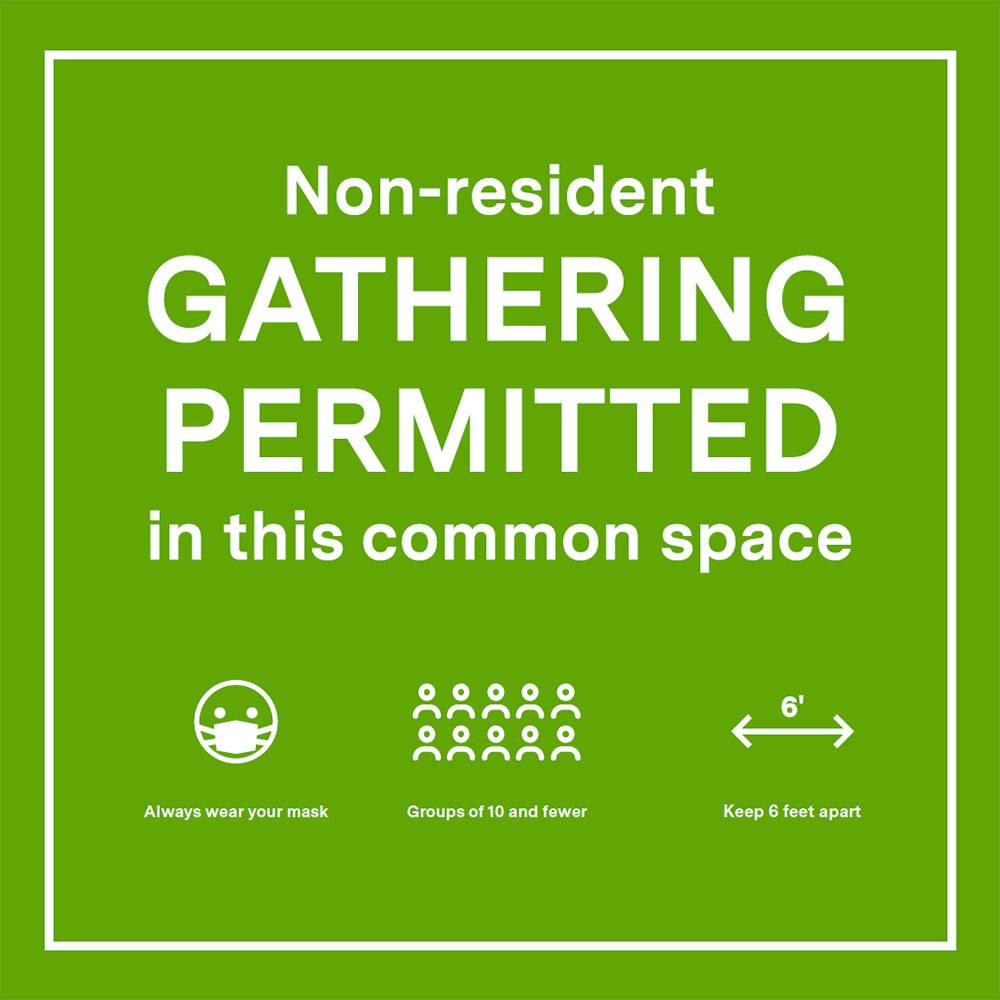 Sign showing that gathering is permitted with physical distancing and face coverings