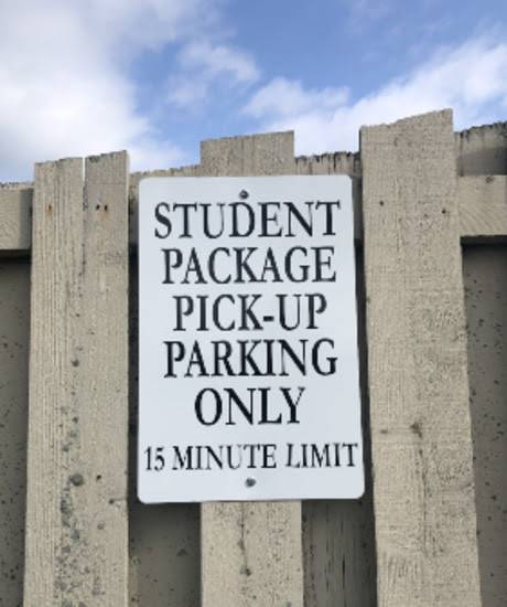 Sign that reads Student Package Pick-up Parking Only, 15 minute limit