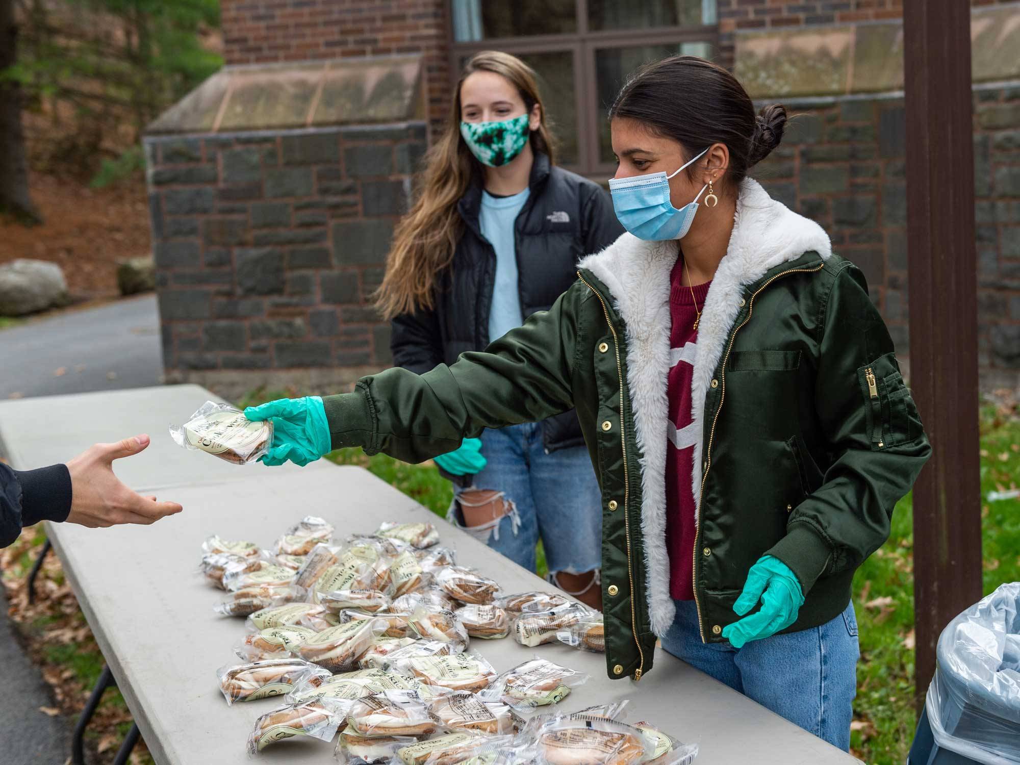 Students hand out ice cream sandwiches on Colgate Day