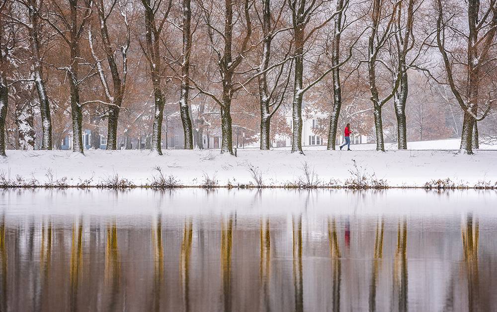 Student in red coat walks along snowy Willow Path