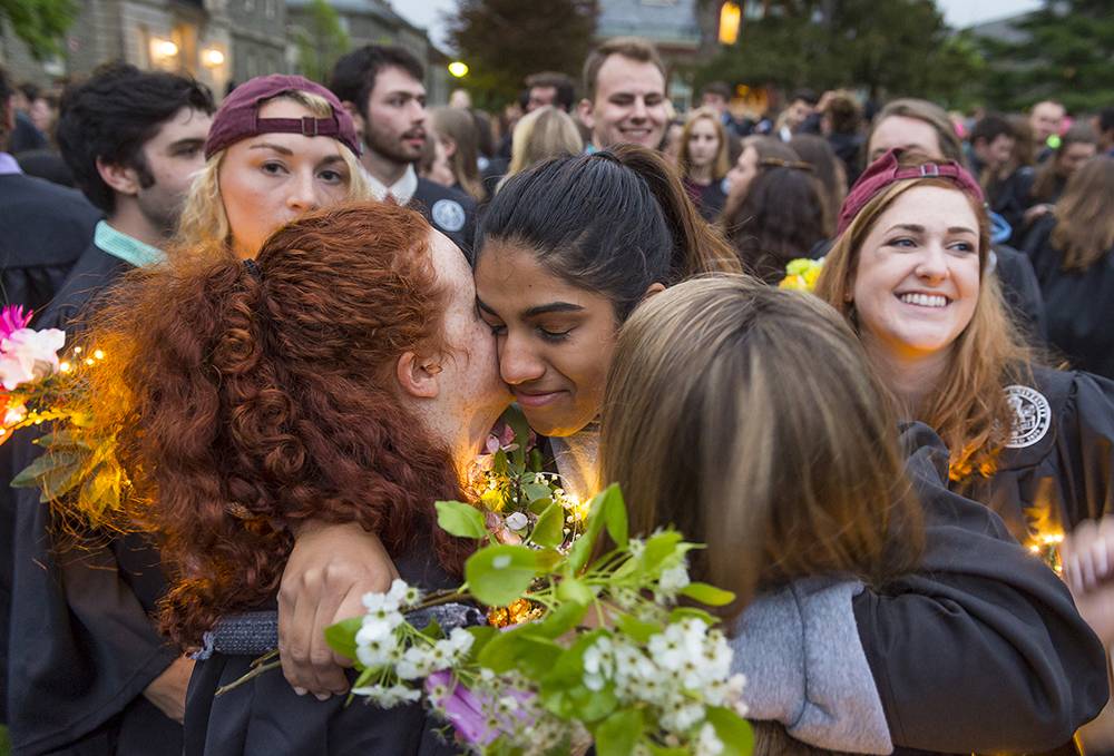 Students embrace during commencement