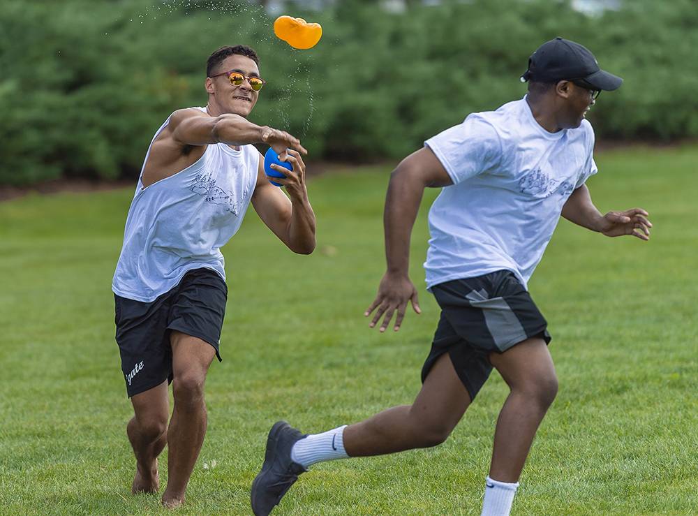 Students participate in a water balloon fight on Whitnall Field