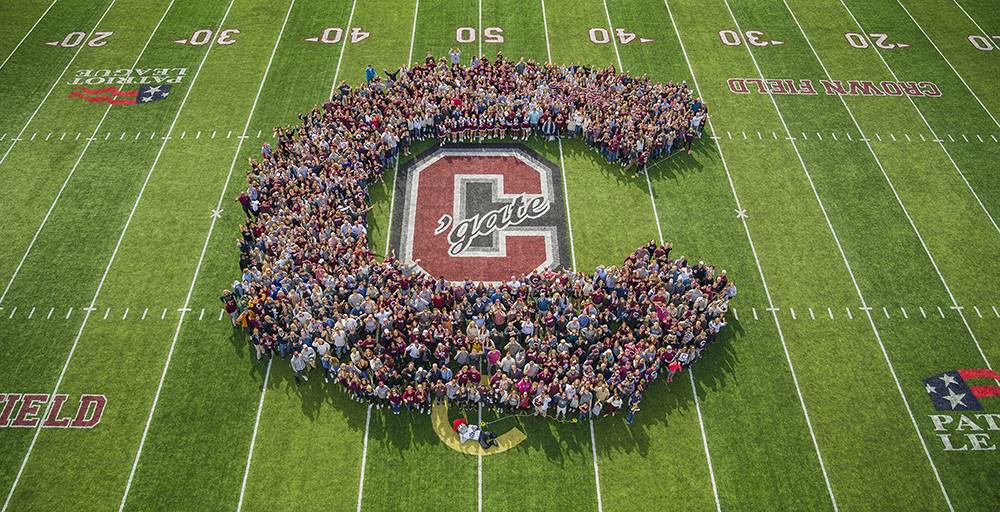 An aerial photograph of a crowd on the football field forming a large Colgate C