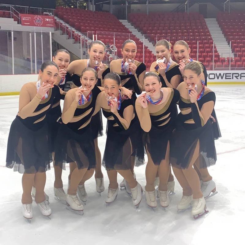 Gabby and other figure skaters with medals.