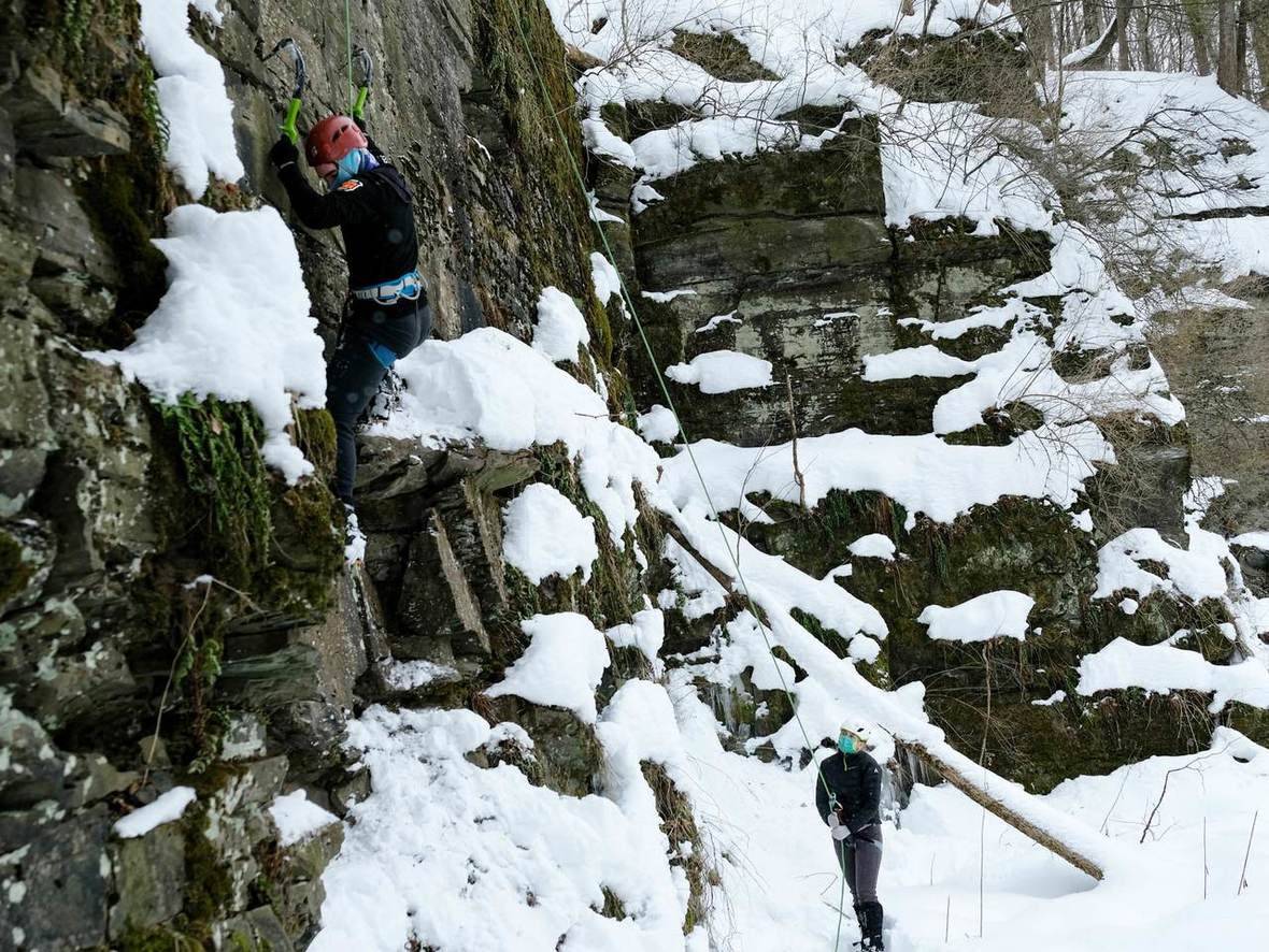Student climbs wall of Colgate rock quarry