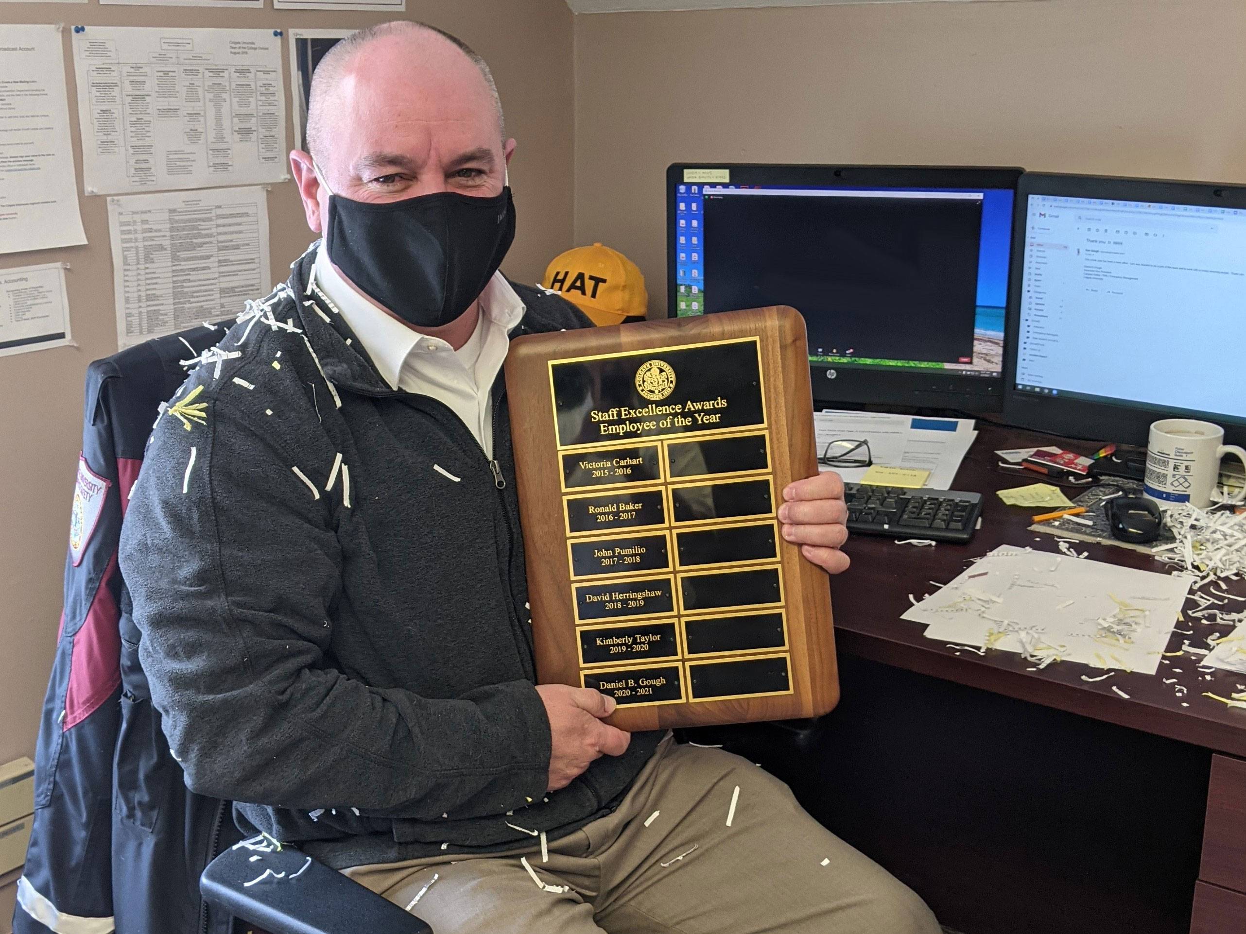 Dan Gough holds Employee of the Year plaque