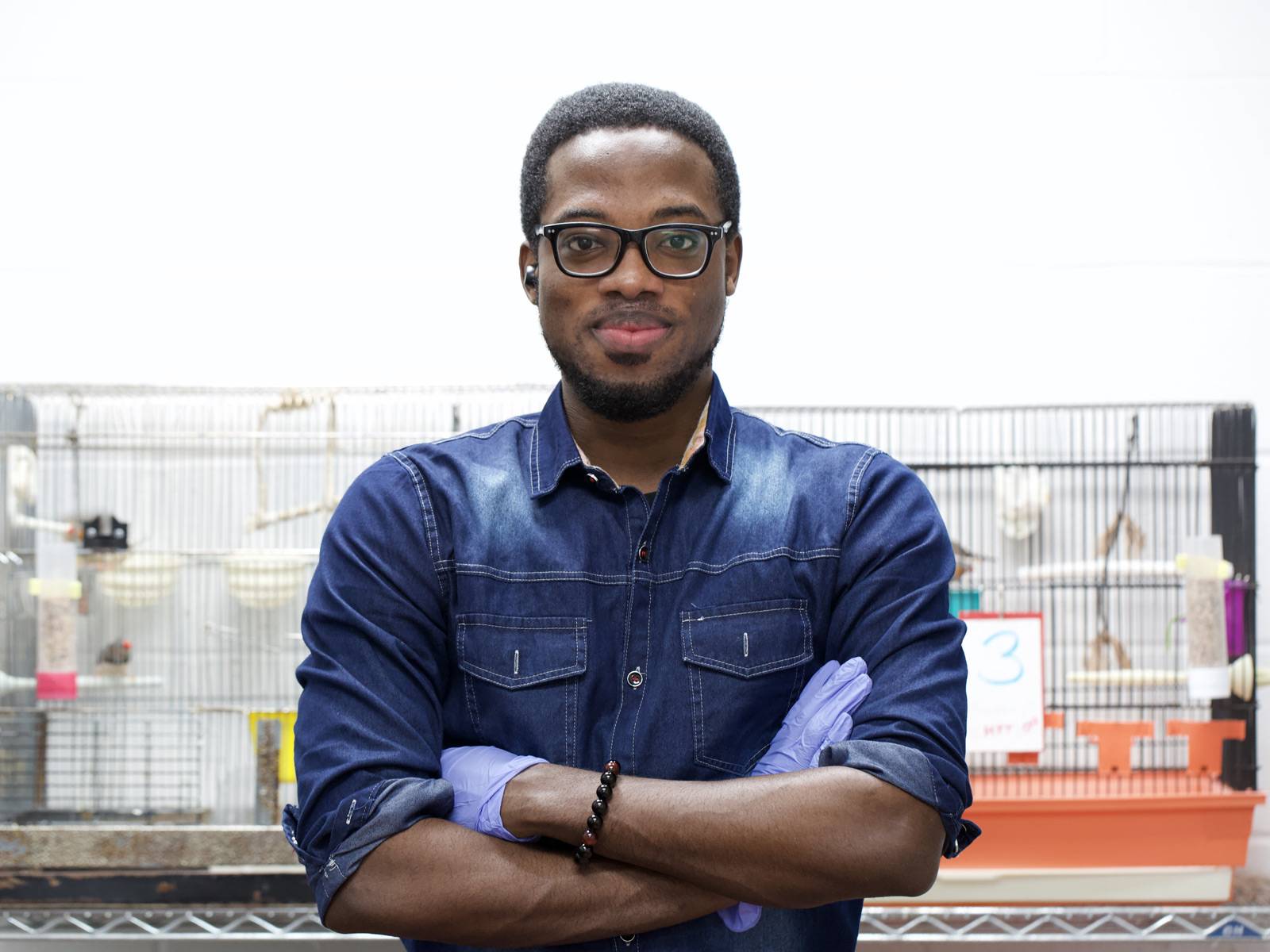 Owusu standing in a lab.