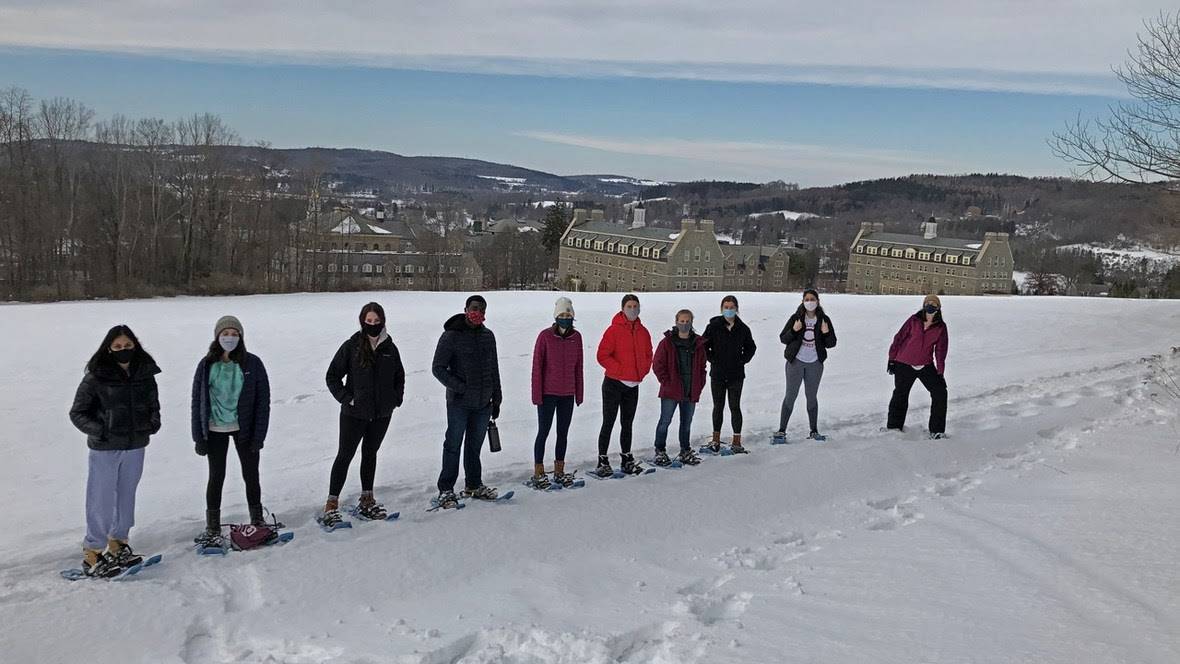 Students in snowshoes on snowy hill