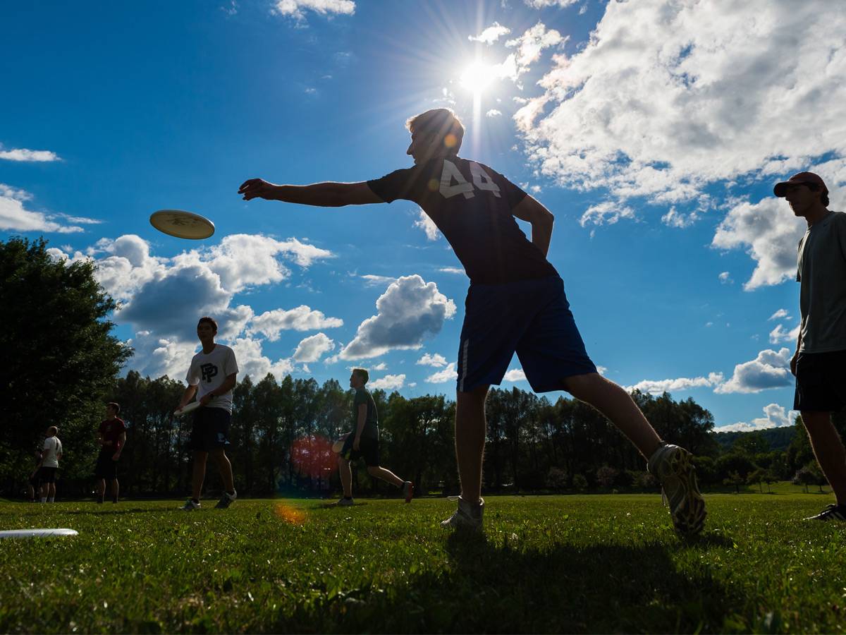 A student playing frisbee.
