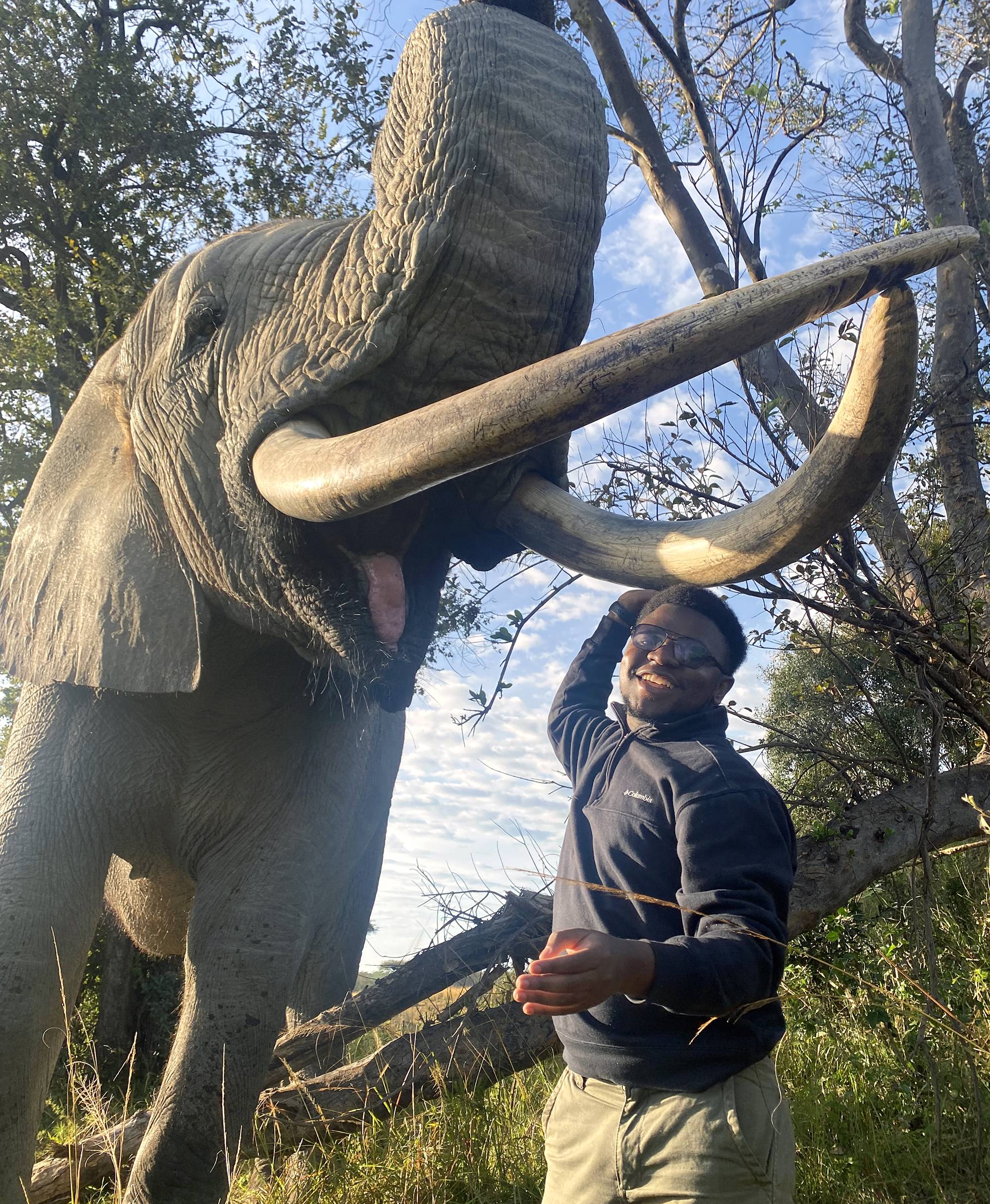 Mac Chirara ’25 at Imire Rhino and Wildlife Conservancy with elephant