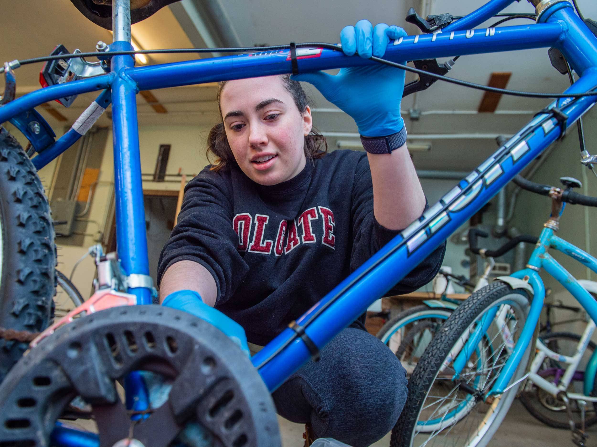 2. Colgate University students work on cleaning donated bicycles at Community Bikes