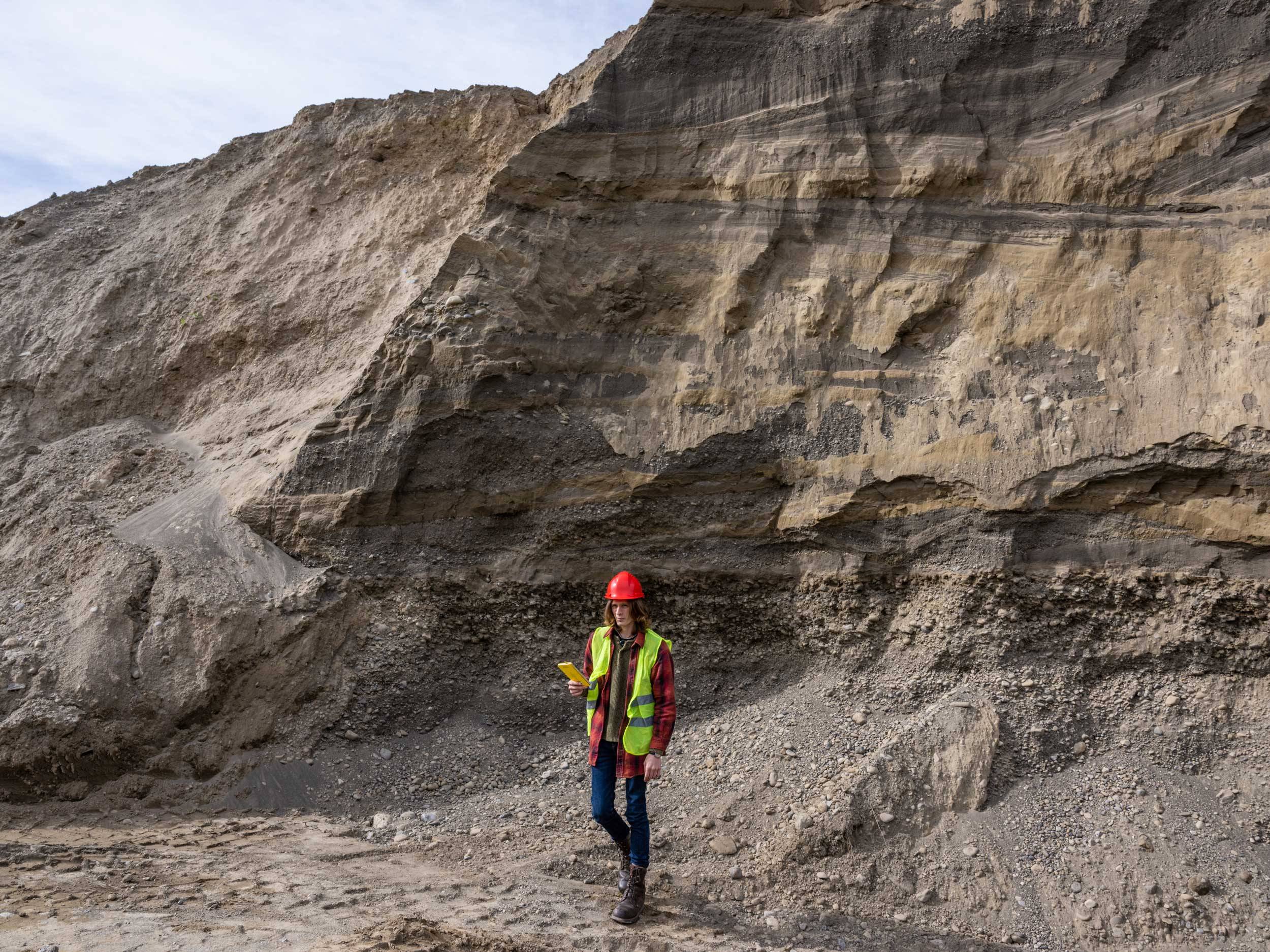student stands in quarry