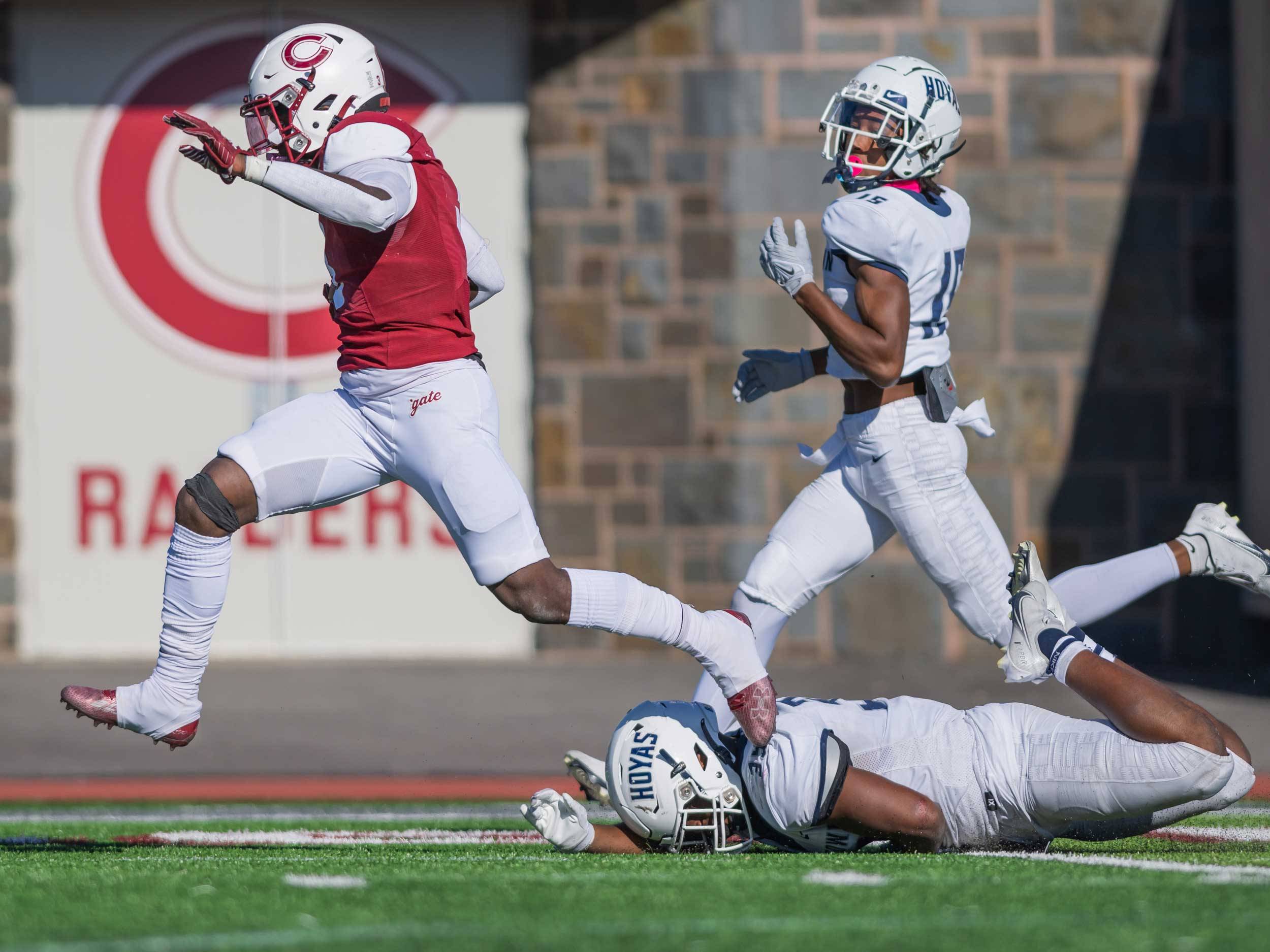 football player runs over defense