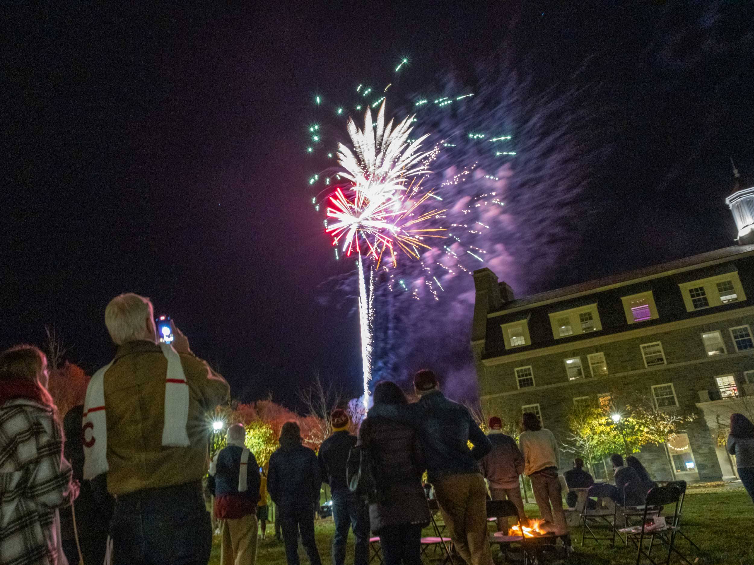 students and families watch fireworks