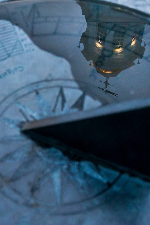 A sundial reflects the image of the Colgate Memorial Chapel