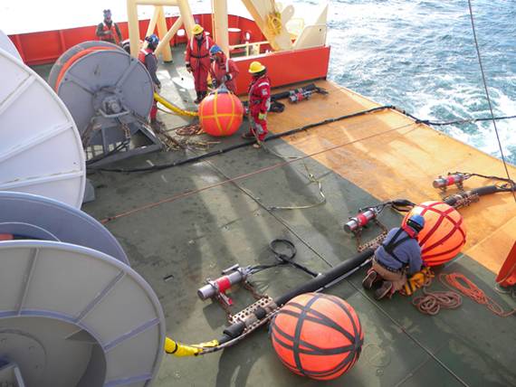 Scientists examine equipment aboard ship