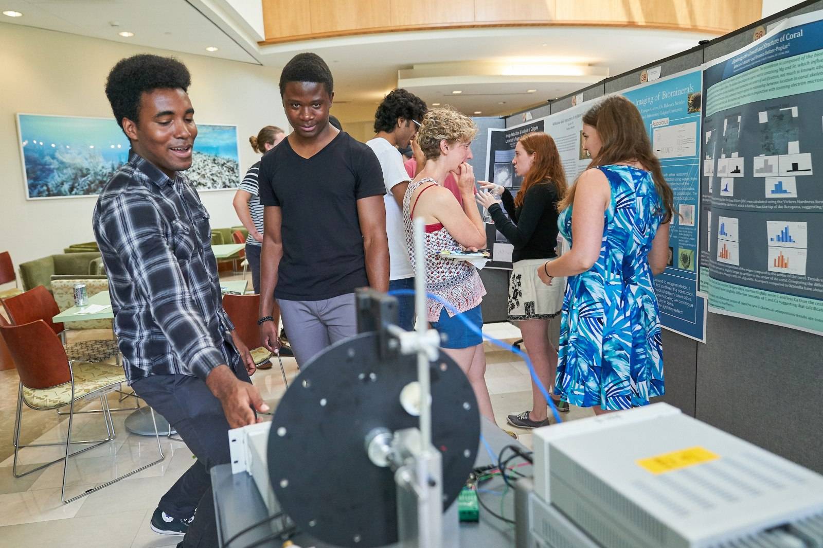 Two students observe a machine