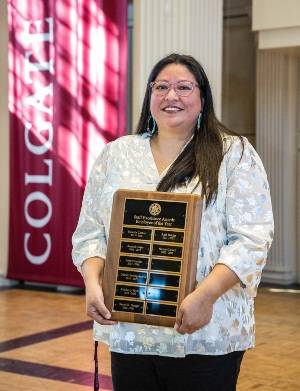 Nicole Carvell with the staff awards plaque