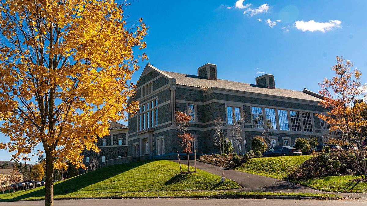 Scenic photo of Benton Hall on the hill during the fall