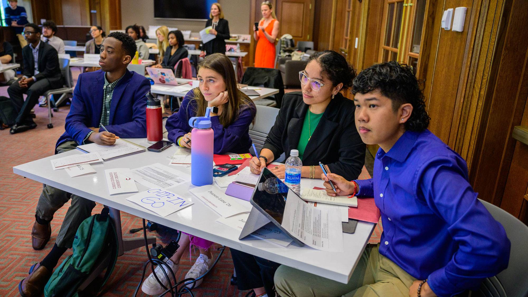 Students at table listening to presentation