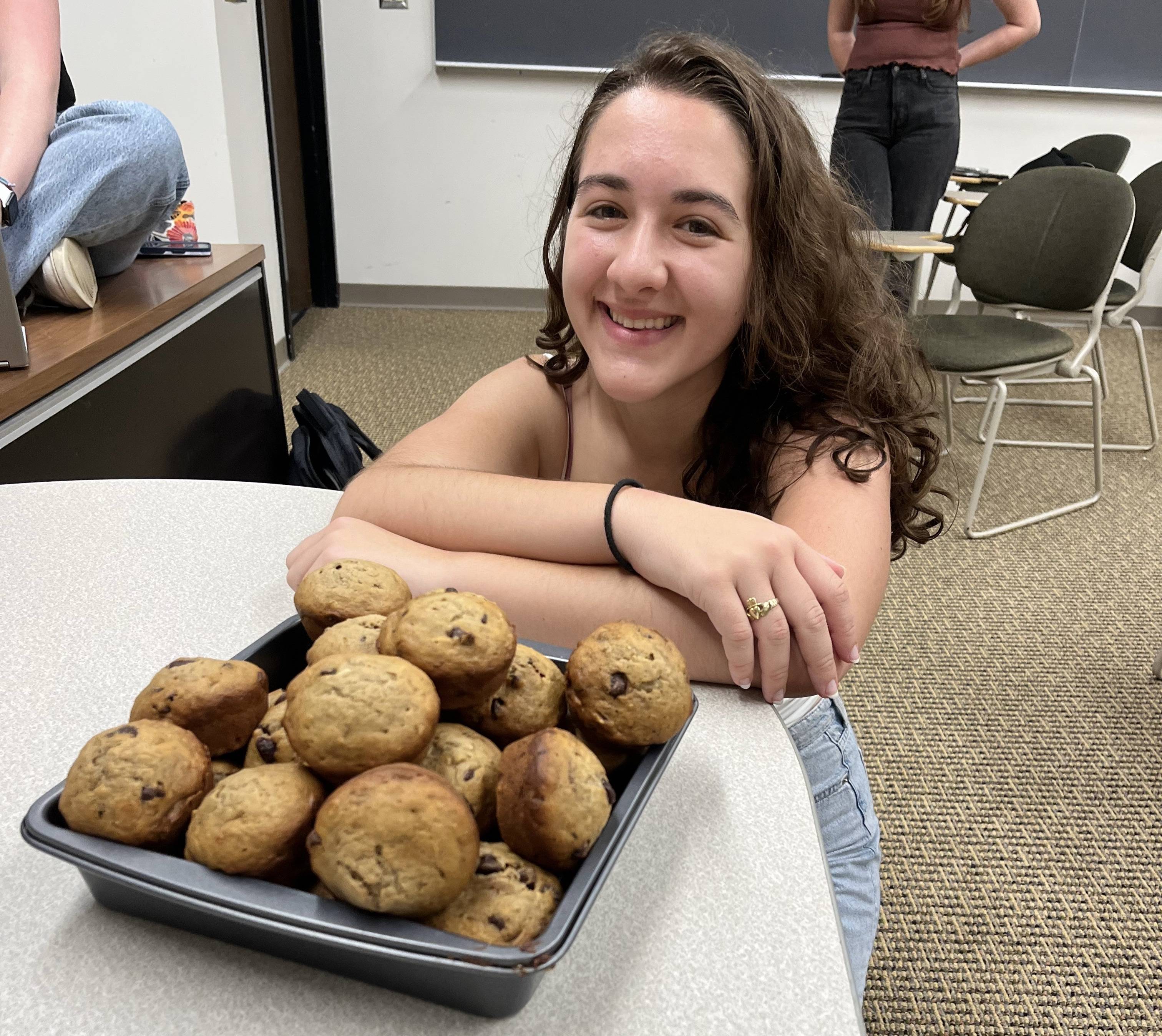 Farrell posing with banana chocolate chip muffins after a successful baking club meeting
