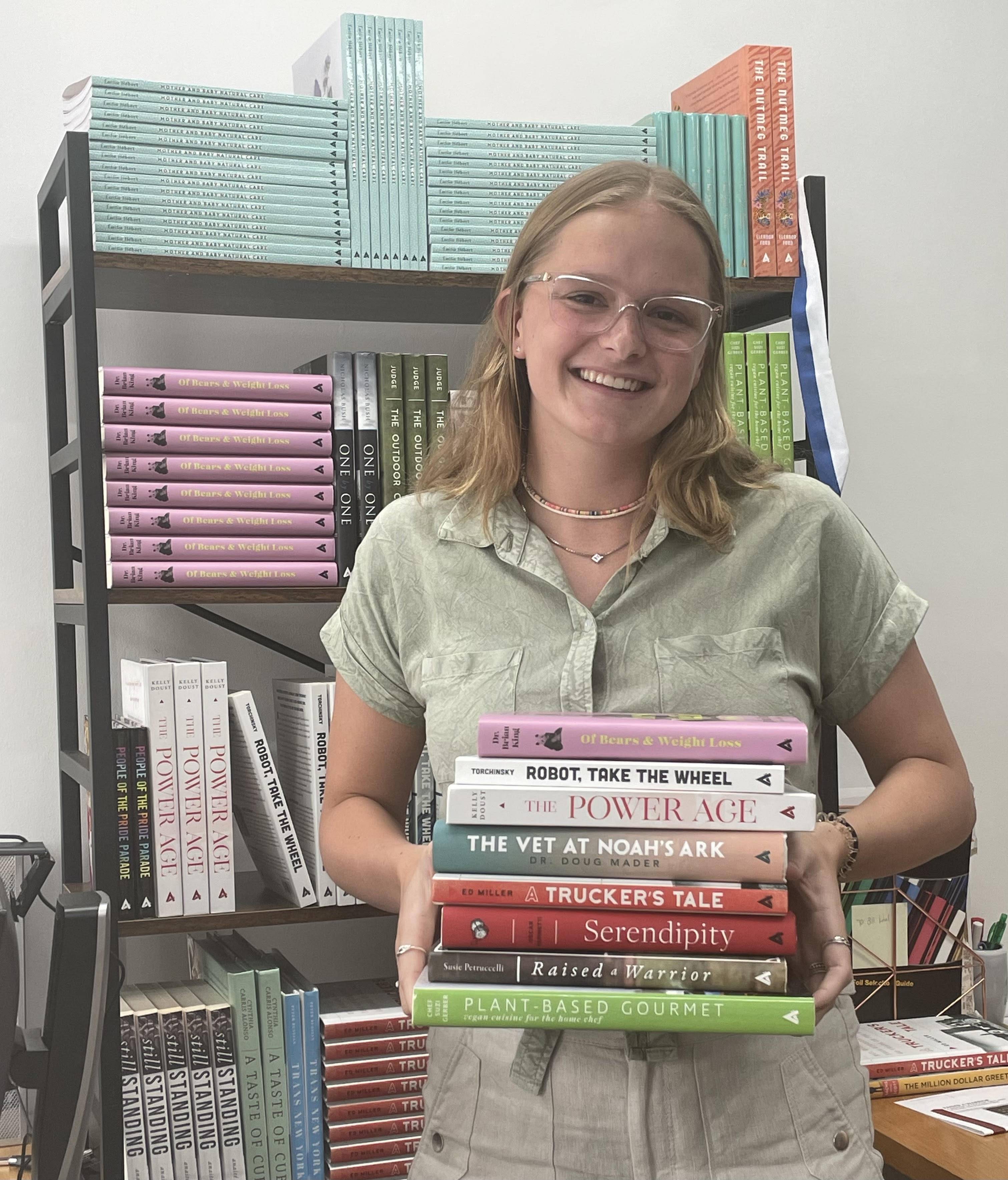 Jesse with the stack of books she worked most closely with at Apollo