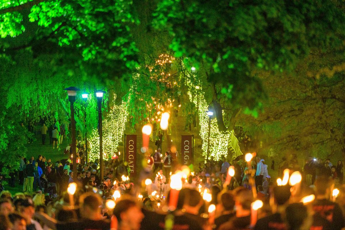 Graduating seniors make their way down Willow Path holding torchlights, an annual rite of passage for University graduates.