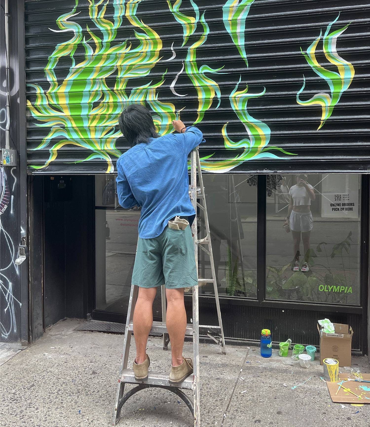 Local artist paints the rolling gate at Olympia Gallery