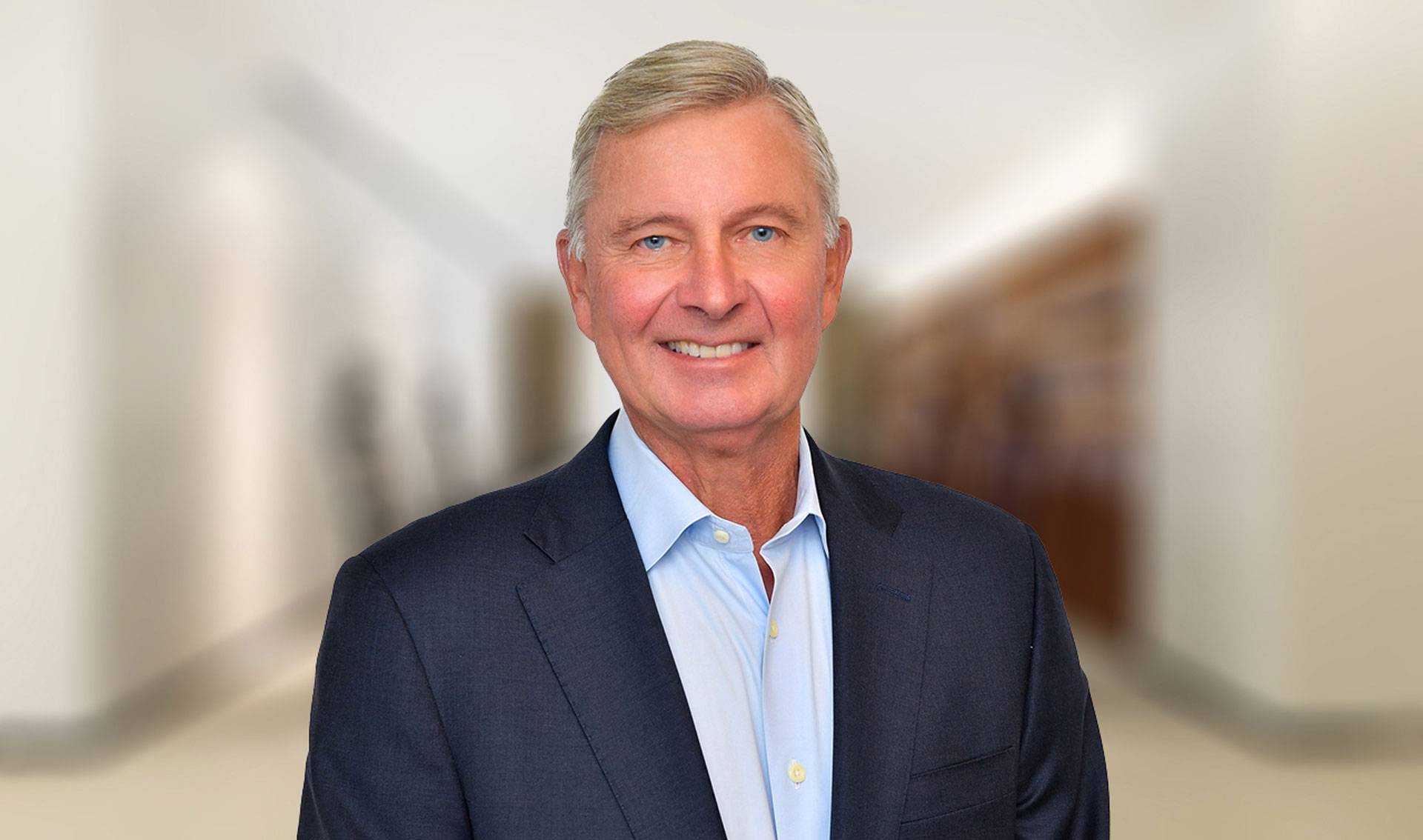 Portrait of Michael Herling wearing a blazer and light blue button down