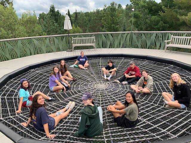 Students sitting on a trampoline