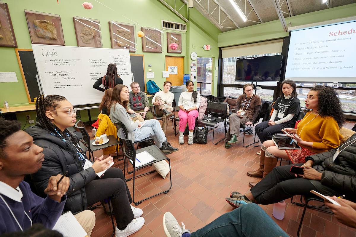 A group of students and employees attend a Social Justice Summit session