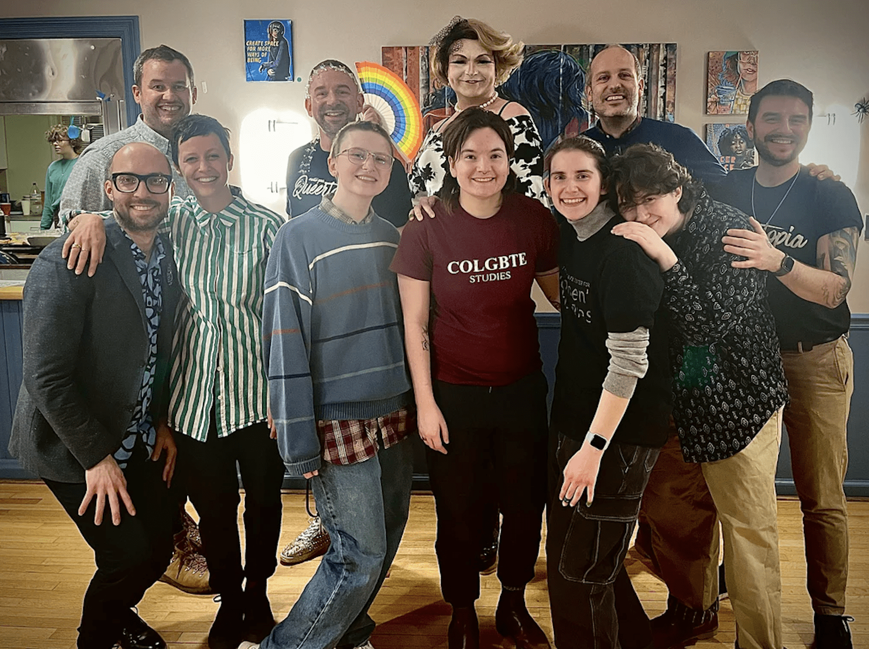 Oscar alongside students, staff, faculty, local drag queen Edie James, and artists Paul Richmond and Briden Schueren celebrating the conclusion of Queertopia at Pink Haus. 