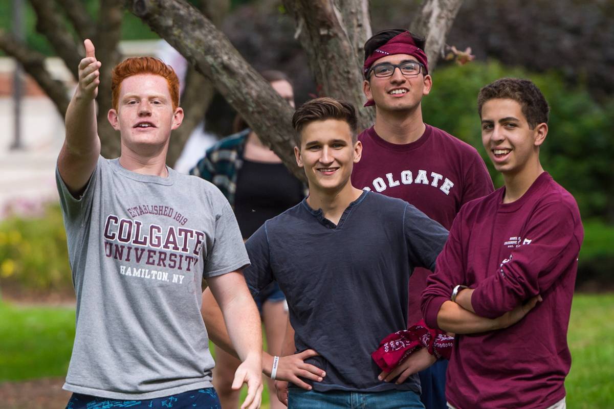 A group of four men gather for field day activities