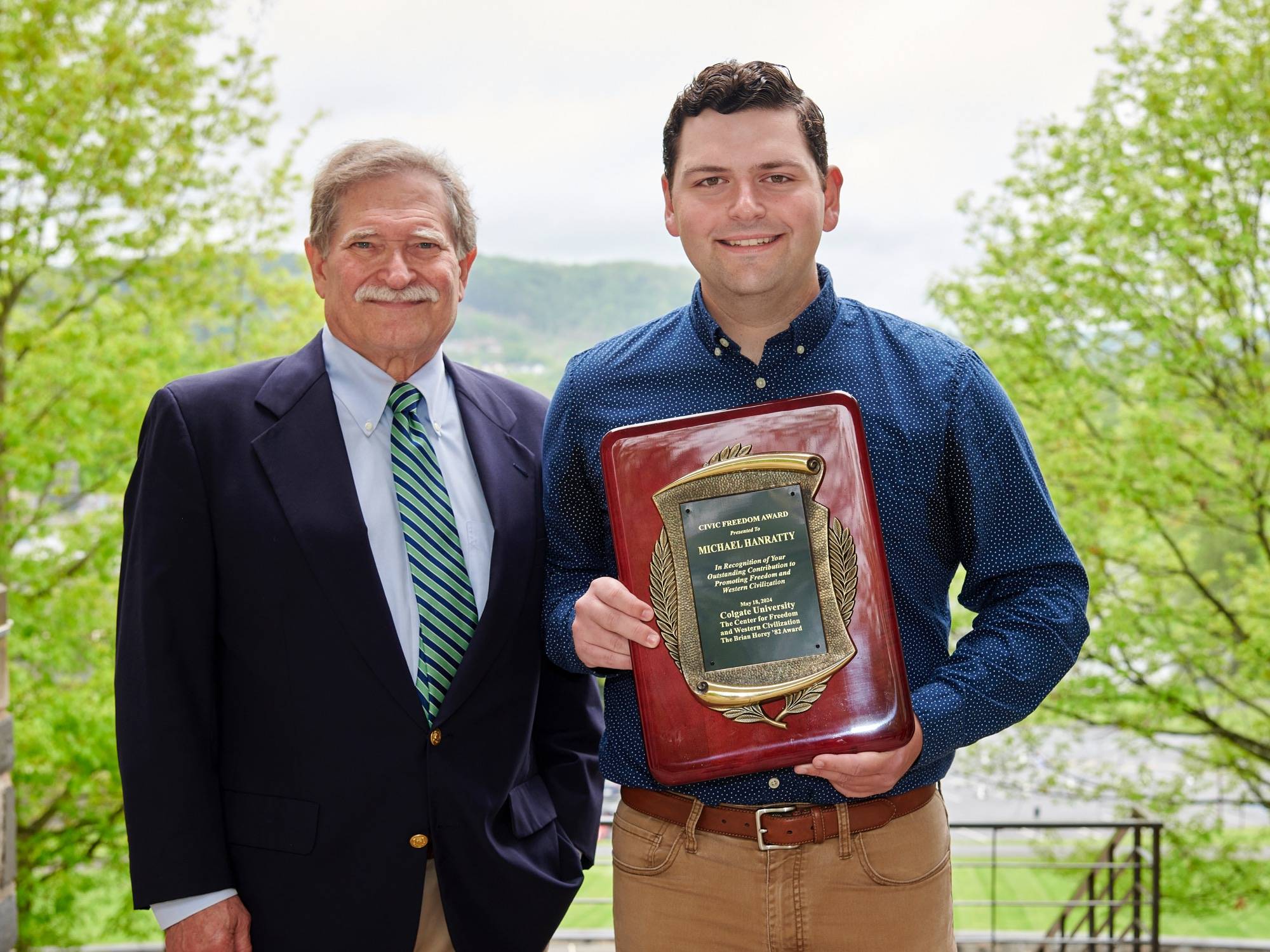 Michael Hanratty ’24 receives the Brian Horey ’82 Civic Freedom Award for 2024, with his faculty sponsor, Professor of Political Science Stanley Brubaker. 