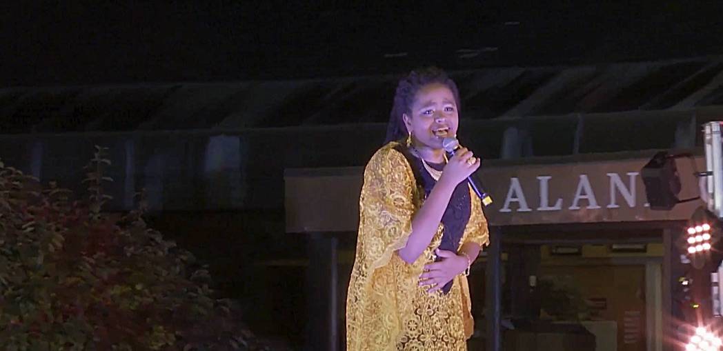 Reem singing the Japanese city pop song "Ride On Time" at the the ALANA Multicultural Fashion Show