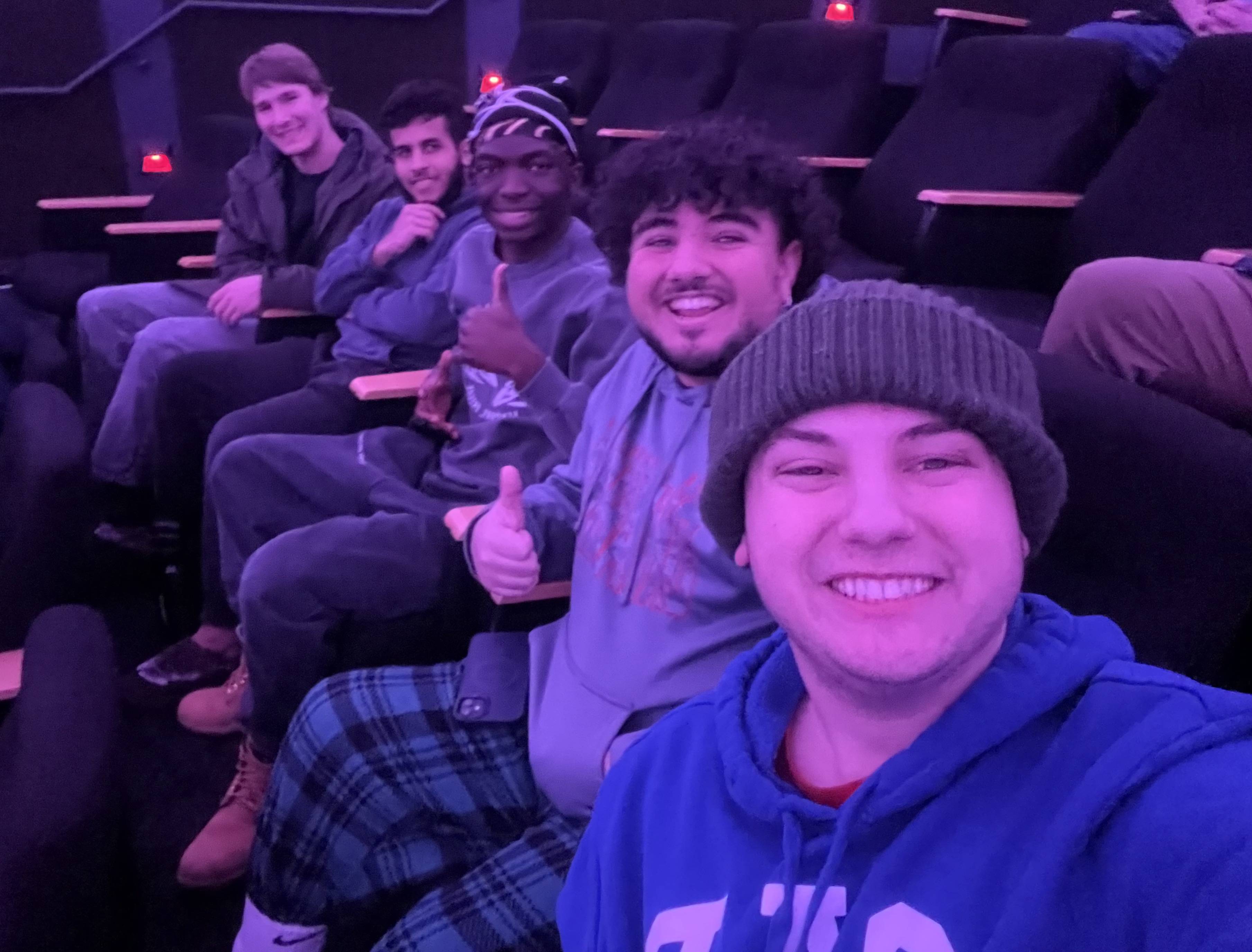 John Paul and friends watching a movie in the Little Hall screening room