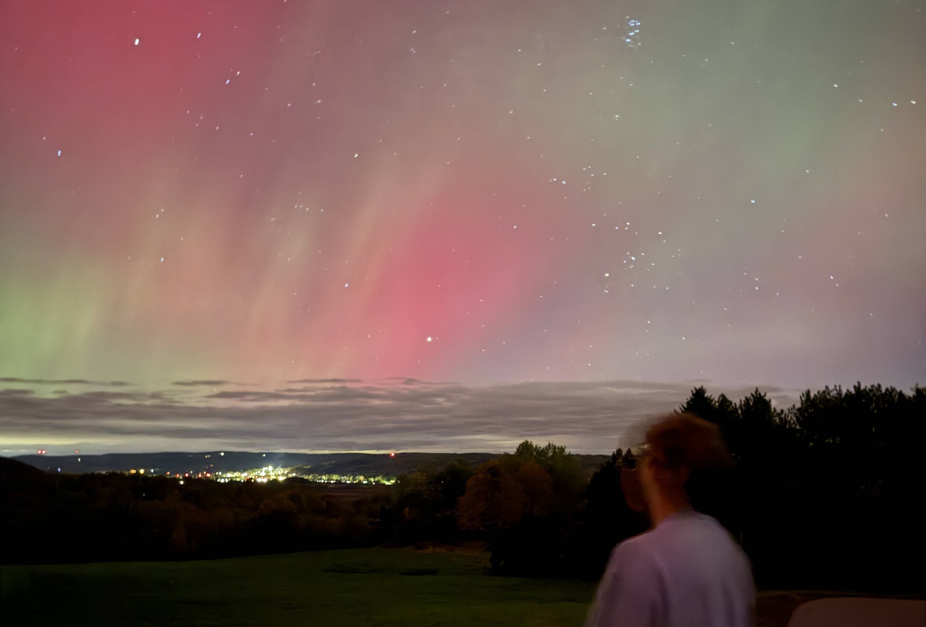 Luke looking across the valley Colgate Campus under the Northern Lights