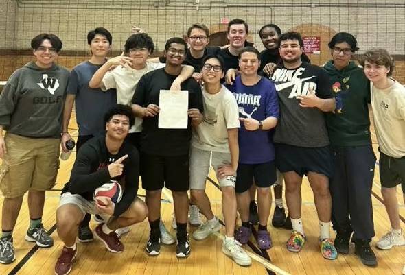 John Paul, alongside teammates at the Division A Volleyball Championship
