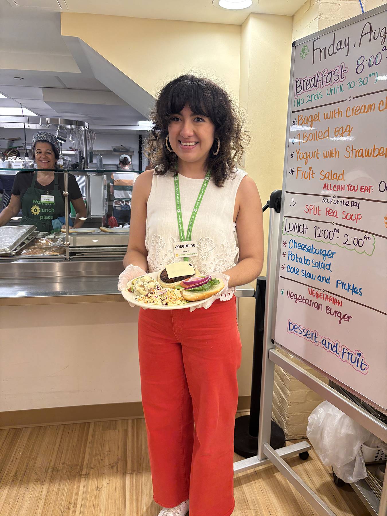 Returning fellow Josephine DeBono ’26 interns at the day shelter Women’s Lunch Place