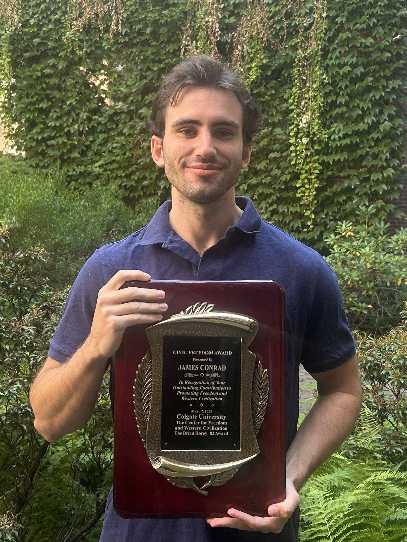 James Conrad photo with 2025 award