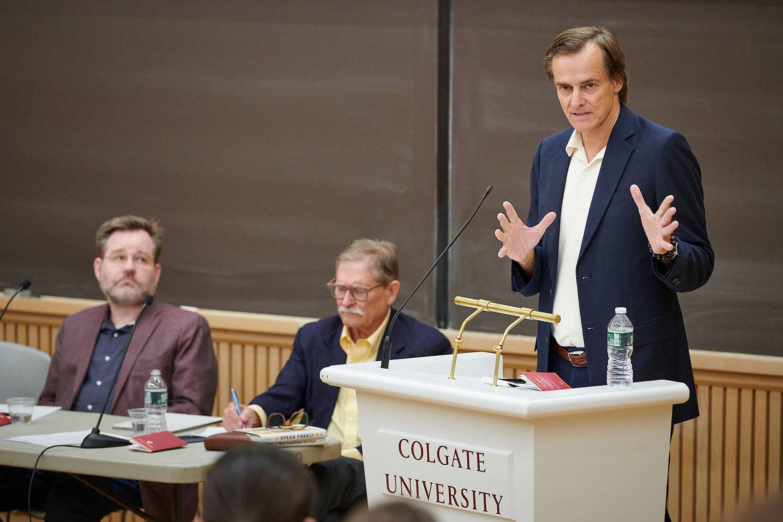 Three men debate during the Constitution Day debate
