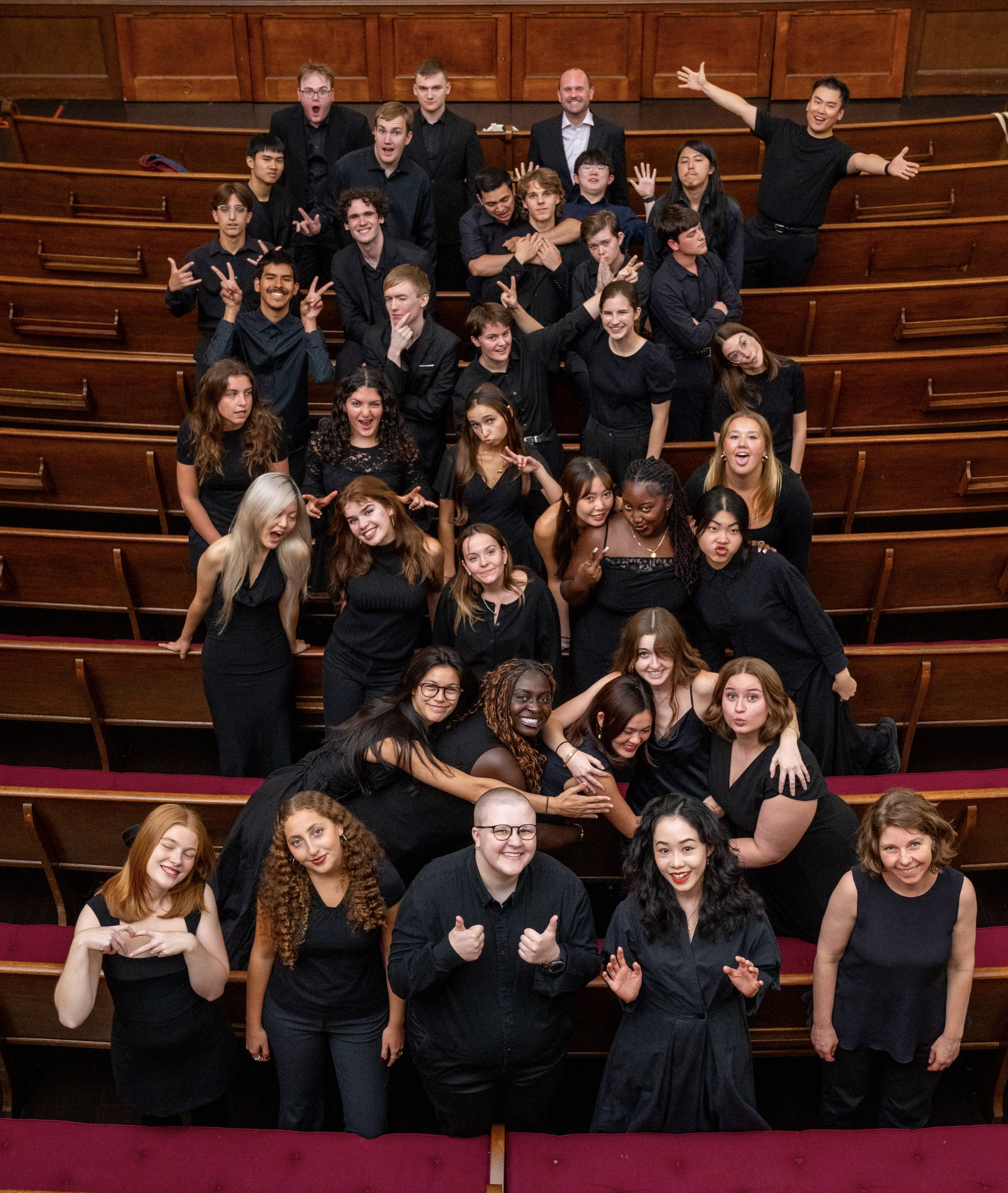 University Chorus members wearing all black and photographed together in fun poses.