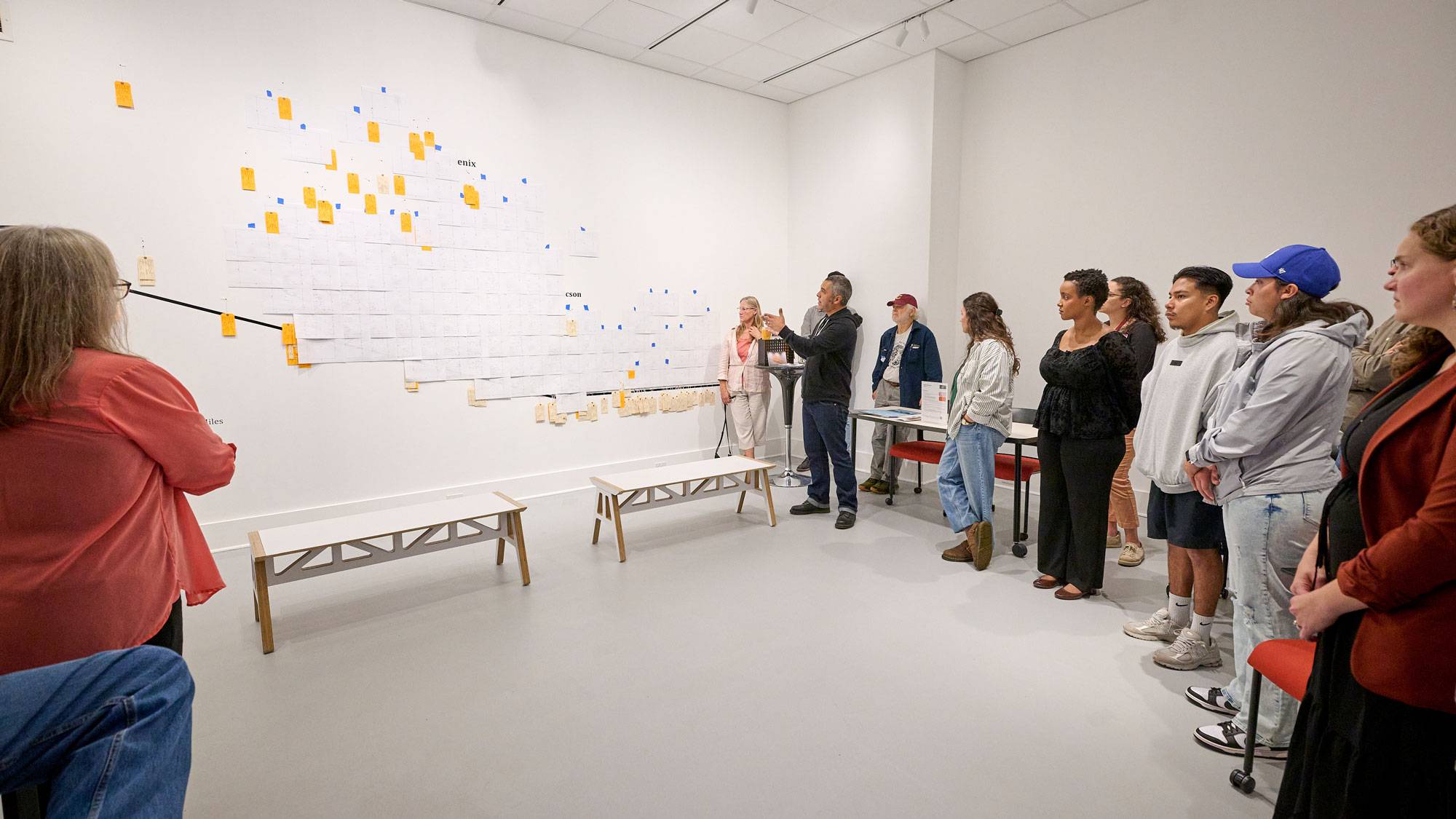 Jason De Léon talks with students, faculty, and staff in front of new exhibition