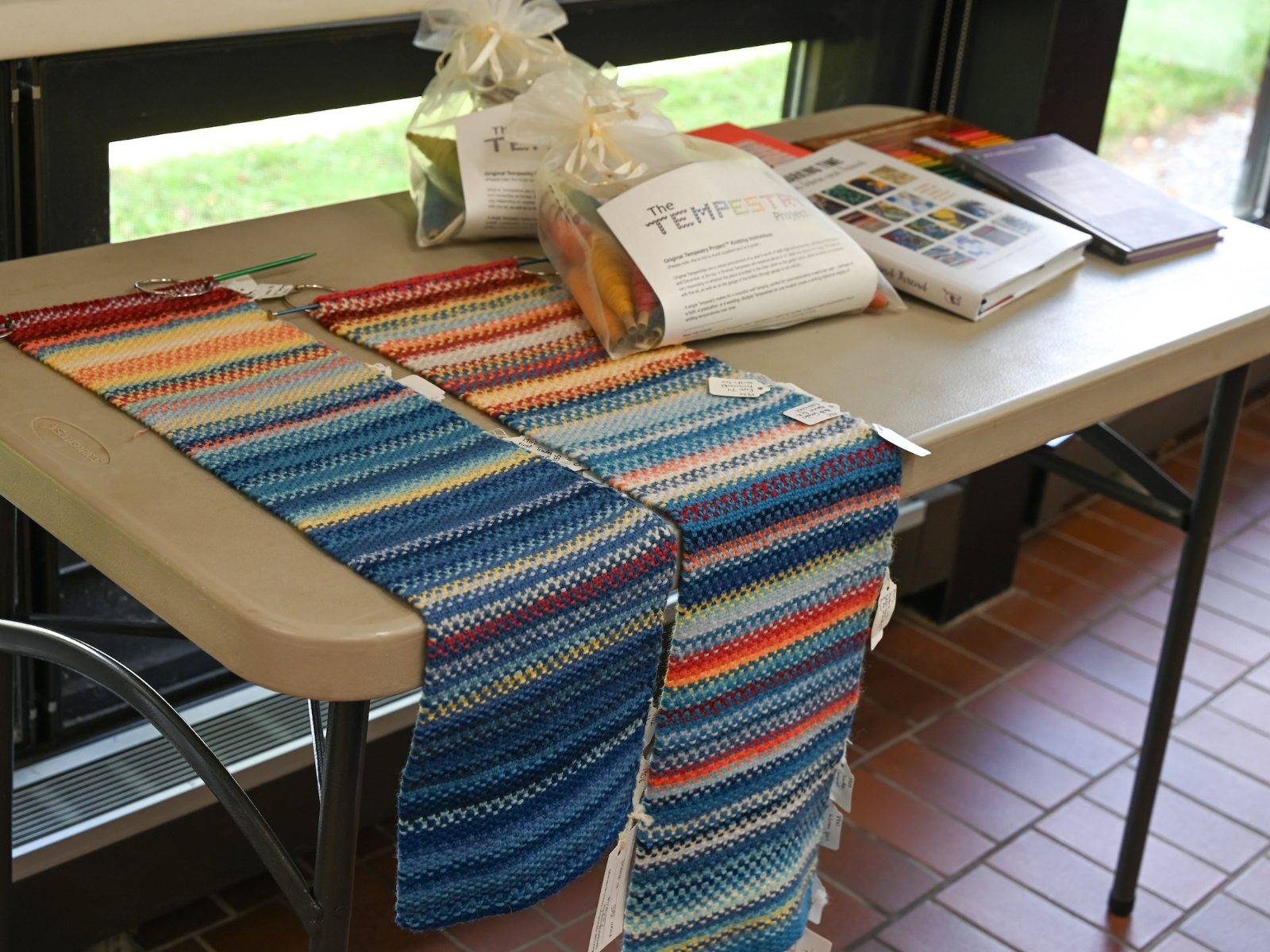 Tempestry Project kits and finished Tempestries are displayed during an ENST Brown Bag, The Tempestry Project — Crafting Climate Communication, Sept 12. 