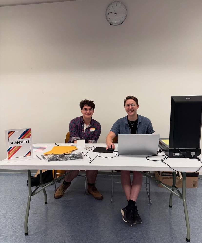 Oscar Brown ’26 (left) helps scan documents for the Boston community