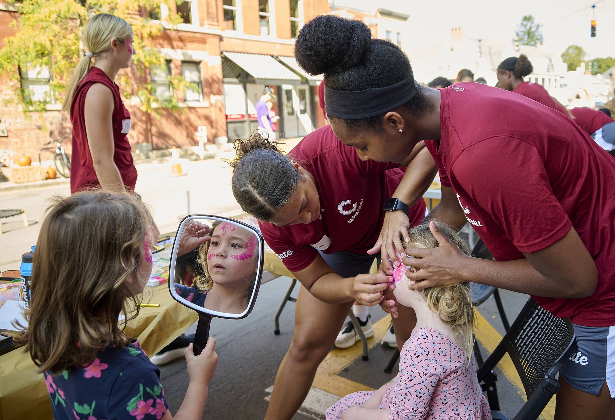 Colgate students volunteer by applying face art in the Village of Hamilton