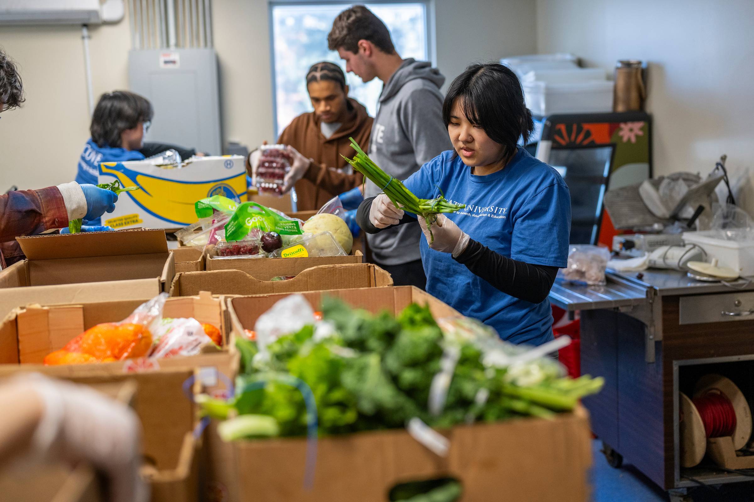 Students sort through produce donations at Hope House