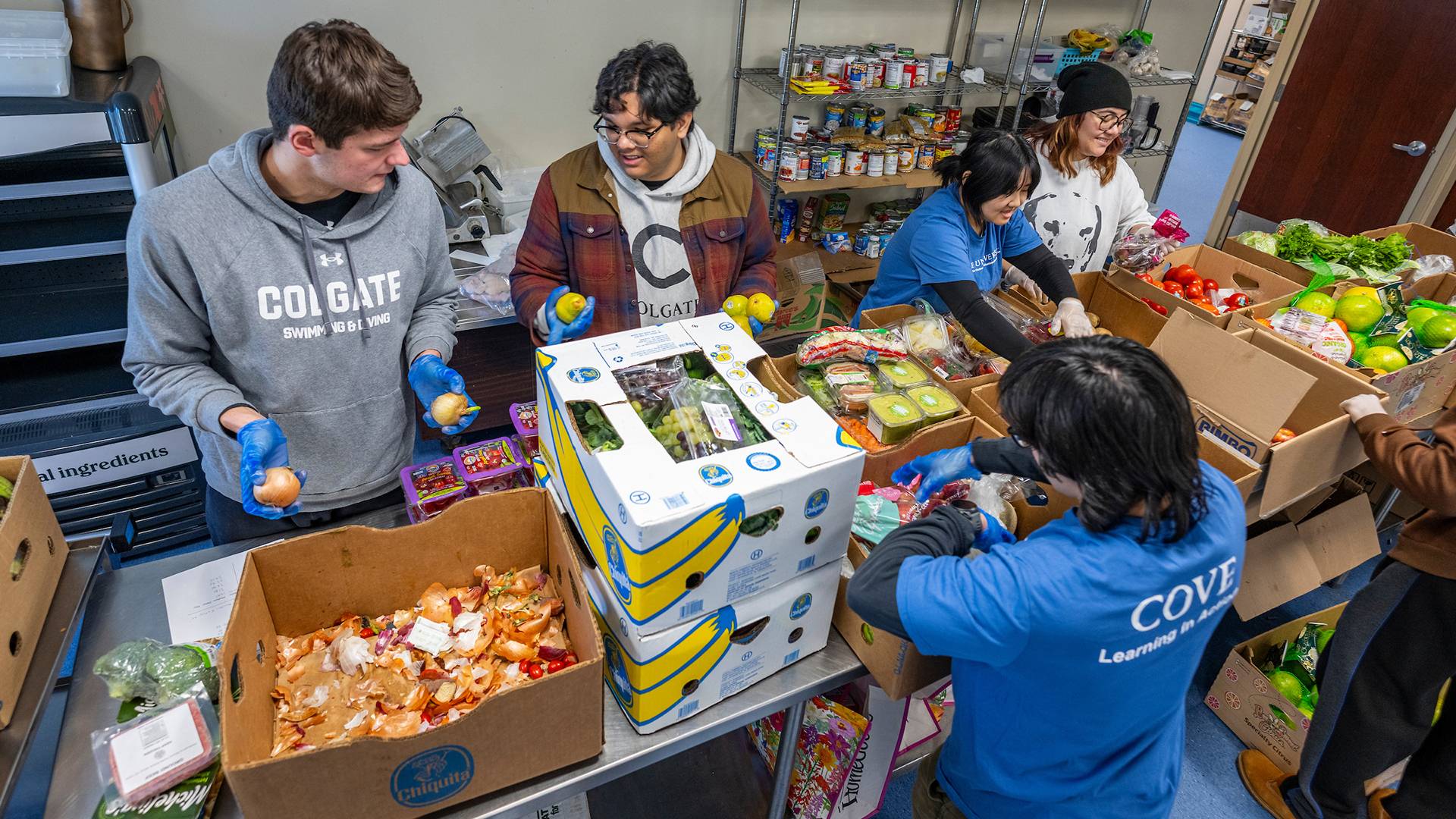 Students sort fresh food items at Hope House to distribute to the local community for an MLK Day of Service project.