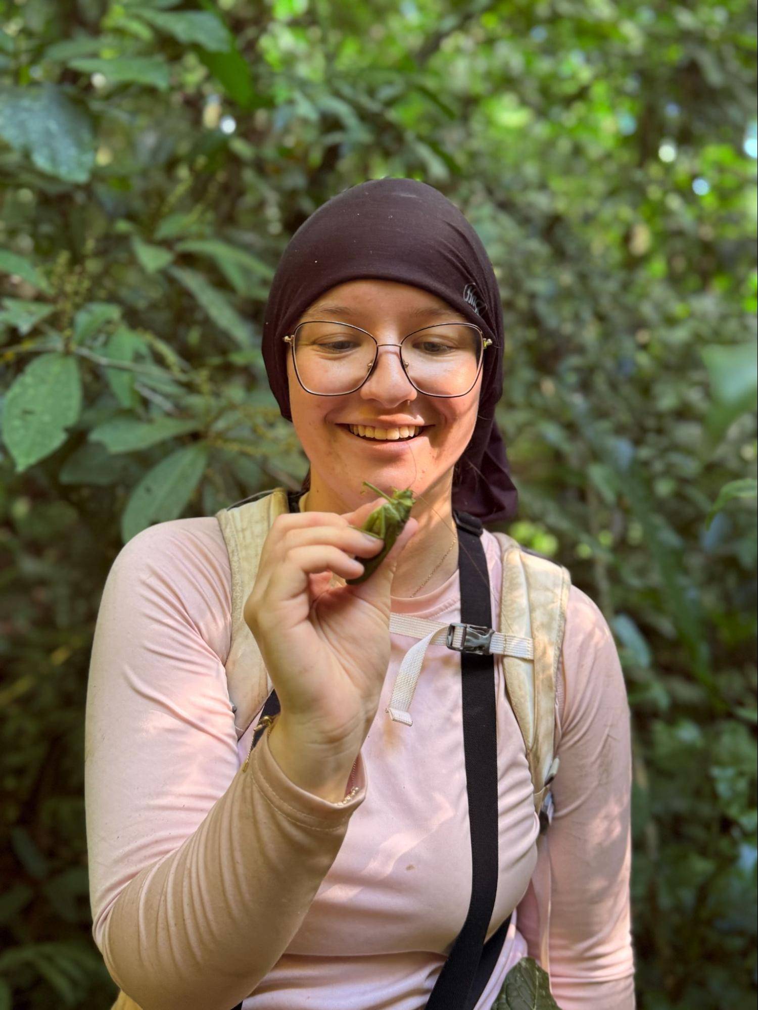 Student examines plants during field research.